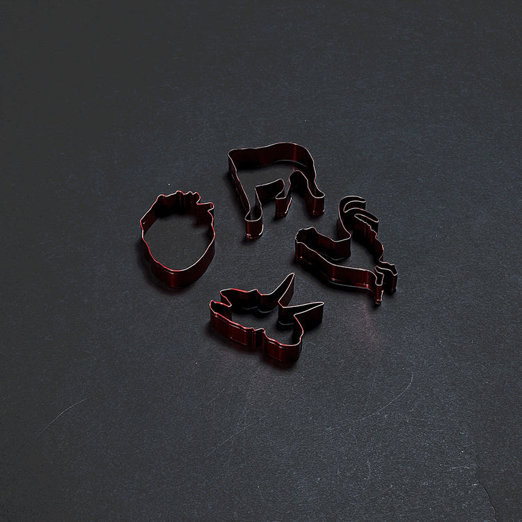 Official Alice in Chains Merchandise. Pack of four red stainless steel cookie cutters featuring shapes from past albums. Each shape will create a 3" cookie.