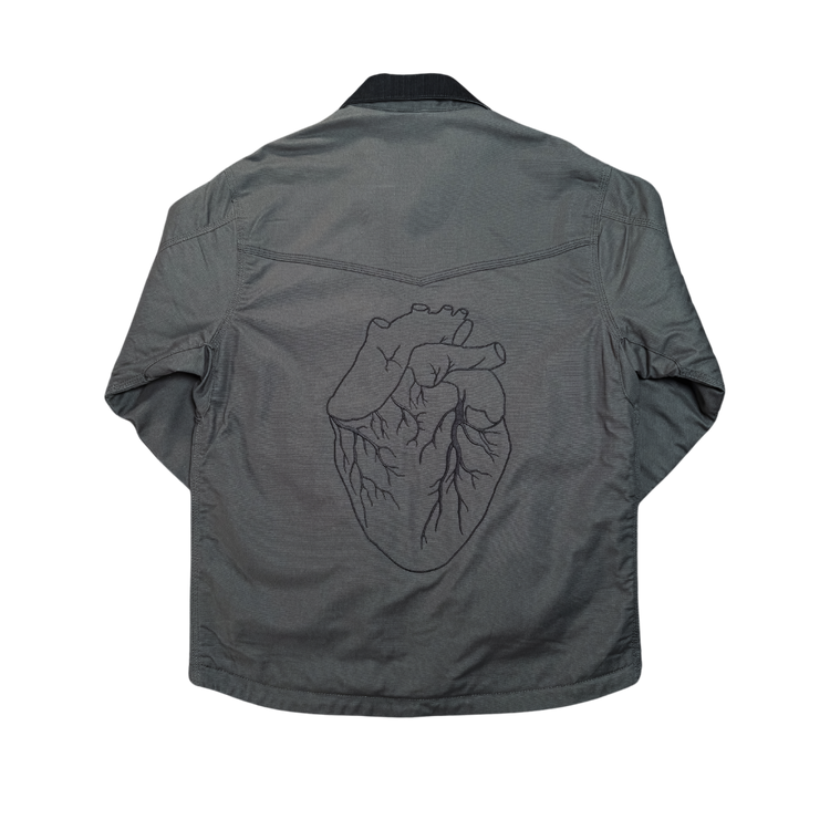 Gray denim work jacket with detailed black embroidered heart design on the back from black gives way to blue collection