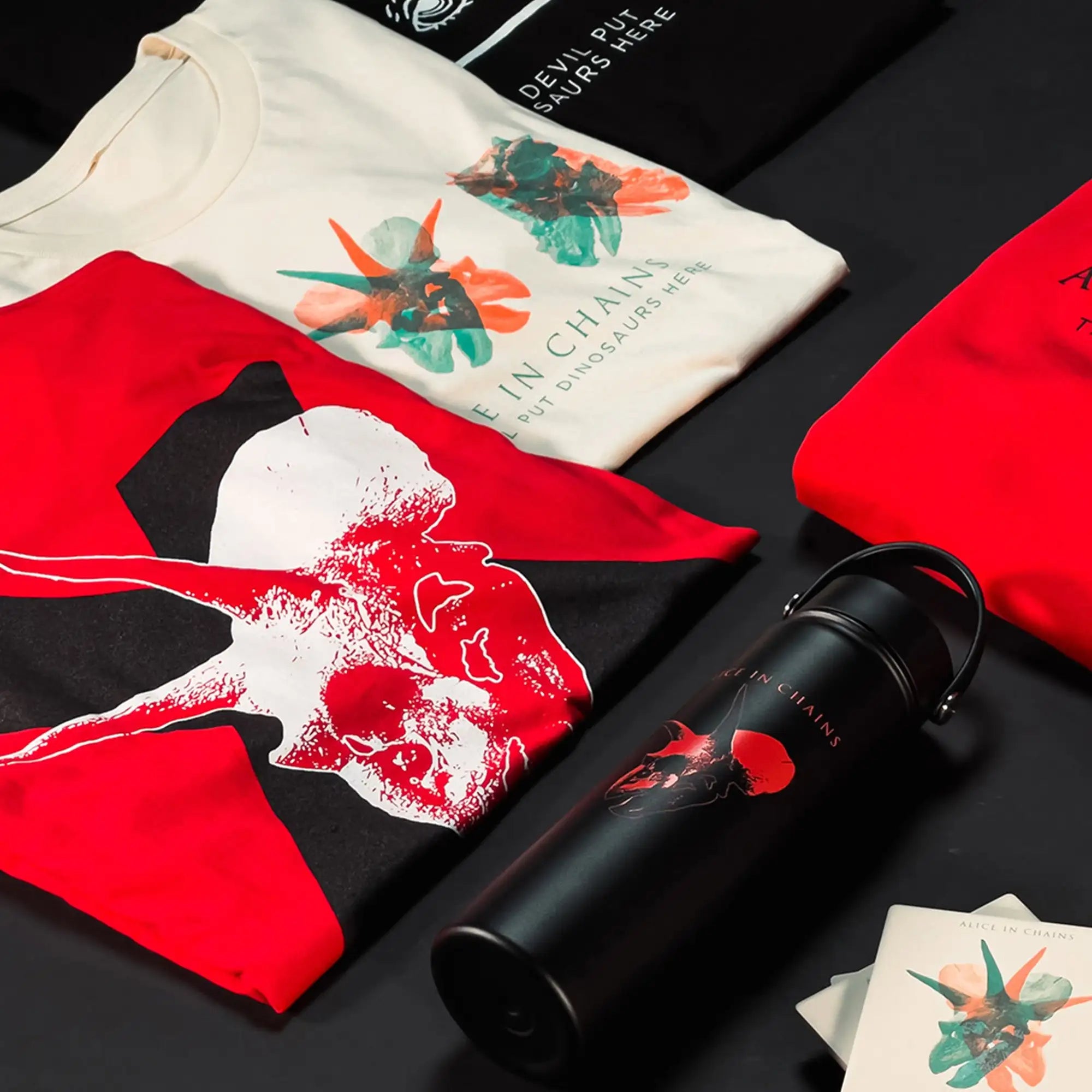Black insulated water bottle with a handle and red dinosaur skull graphic