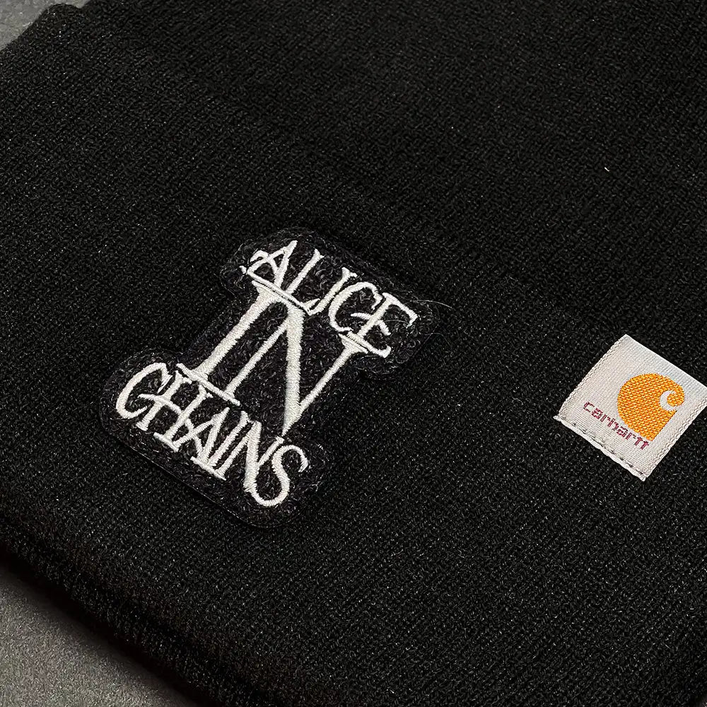 Official Alice in Chains Merchandise. 100% acrylic, black rib knit beanie featuring an embroidered Alice In Chains logo and a Carhartt® label sewn on left side.