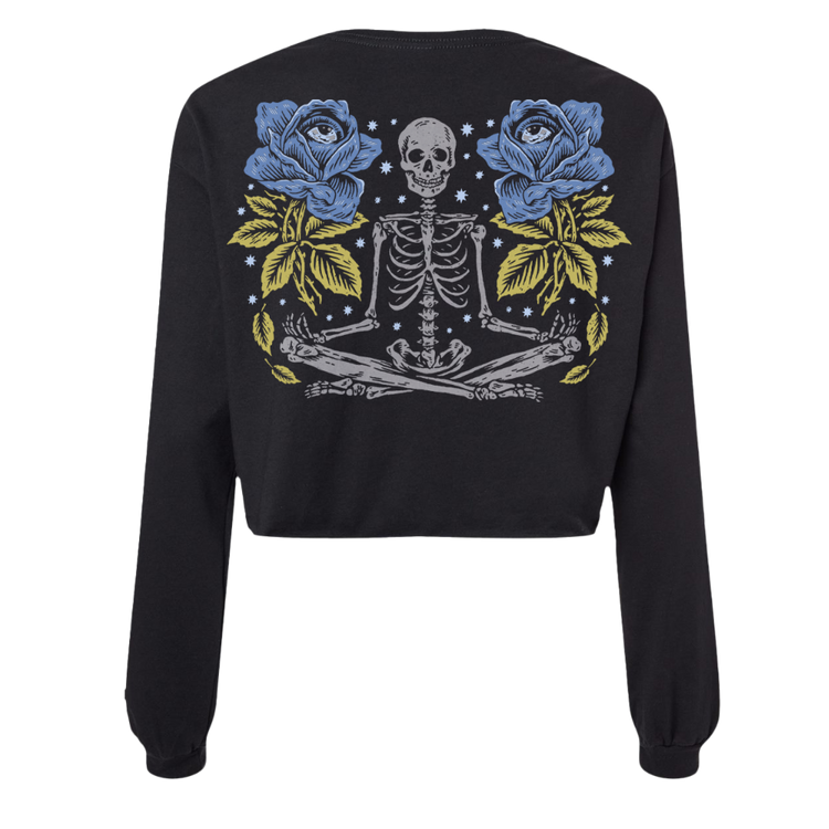 Black cropped sweatshirt featuring a detailed graphic of a skeleton meditating between two blue roses with yellow leaves and starry background.